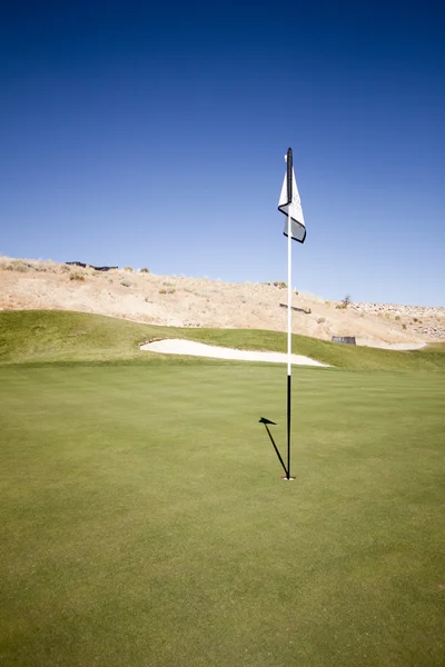 Golf course flag on the putting green grass landscape golfing Stock Picture