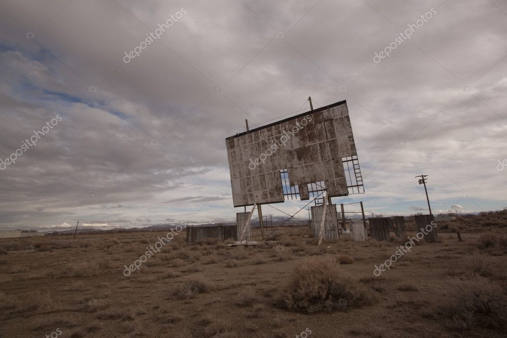 Old abandoned drive-in movie theater on a cloudy day desert — Stock ...