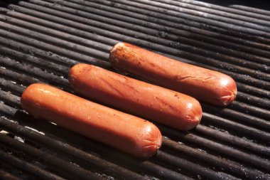 Hot dogs on a bbq clipart