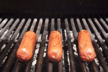 Hot dogs on the grill in summer