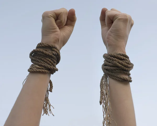 Tied hands with broken rope — Stock Photo, Image