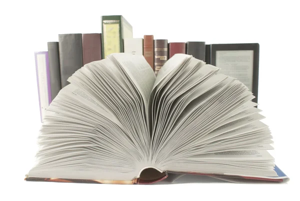 Open book with a row of books and ebook behind it on white background — Stock Photo, Image