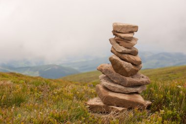 Stack of stones laying in the mountains clipart