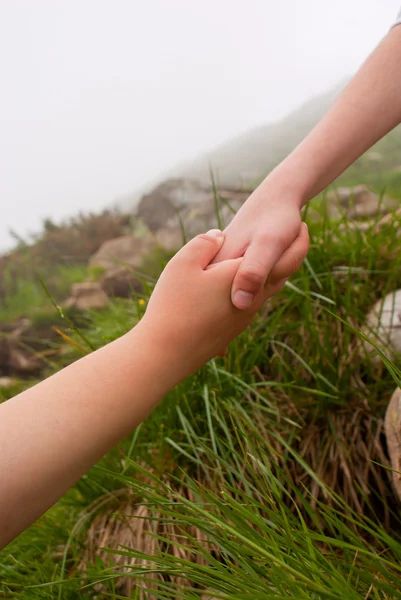 Reaching hands - help of friend — Stock Photo, Image