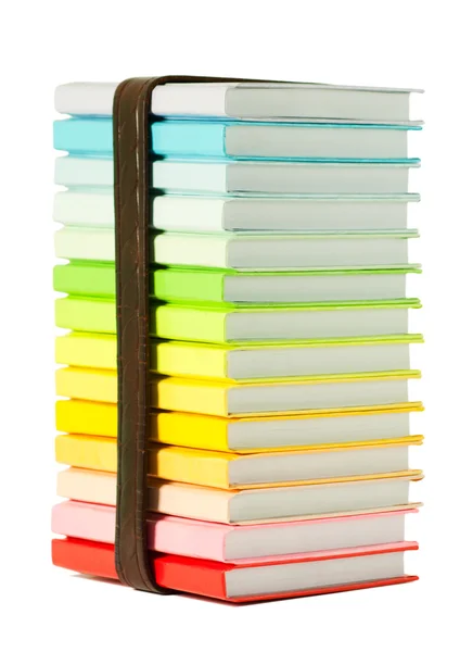 Stack av färgglada böcker på den vita bakgrunden — Stockfoto