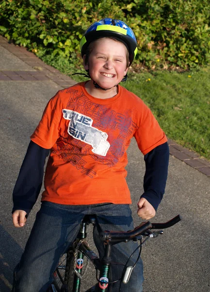 Funny boy on the bike with helmet — Stock Photo, Image