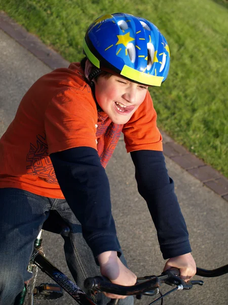 Funny boy on the bike with helmet — Stock Photo, Image