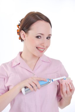 Girl with electric toothbrush clipart