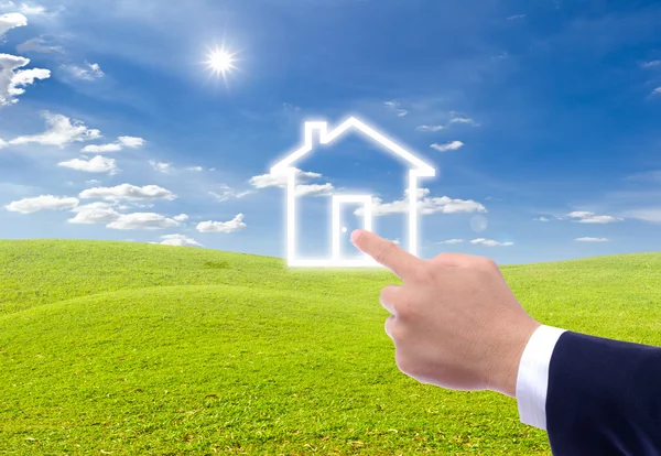 Hand pointing to house icon — Stock Photo, Image