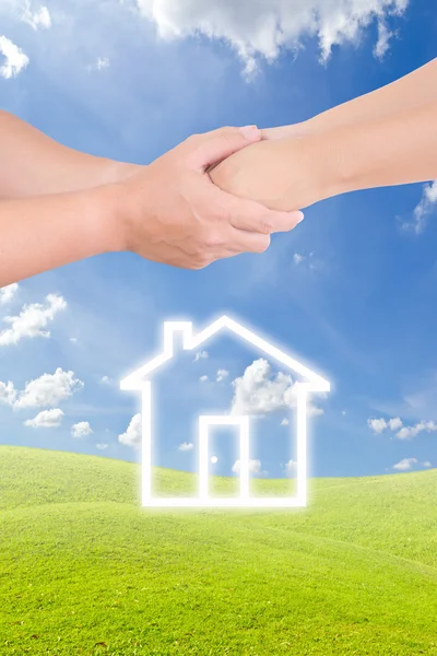 Holding hand and house icon — Stock Photo, Image