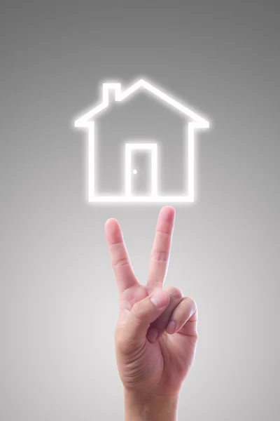 Hand zeigt auf Haus-Ikone — Stockfoto