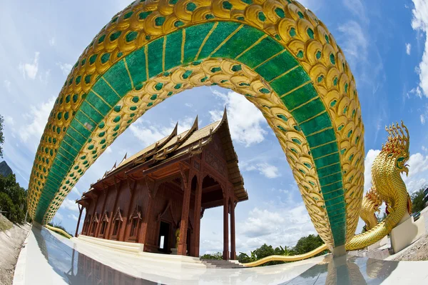 Wild angle in front of Thai teak temple — Stock Photo, Image