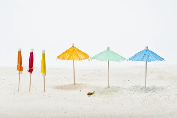 Colorful umbrella on sand — Stock Photo, Image