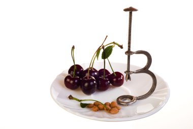 Cherries and pitter on plate clipart