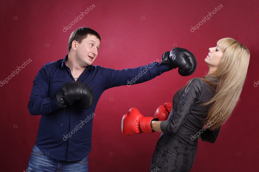 Attractive family couple in boxing gloves on red Stock Photo by ©Vo0001