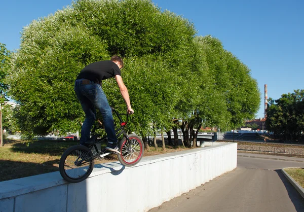 Boy jumping from wall on bmx Stock Photo