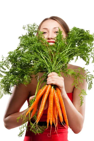 Attractive woman holds bunch of carrots — Stock Photo, Image