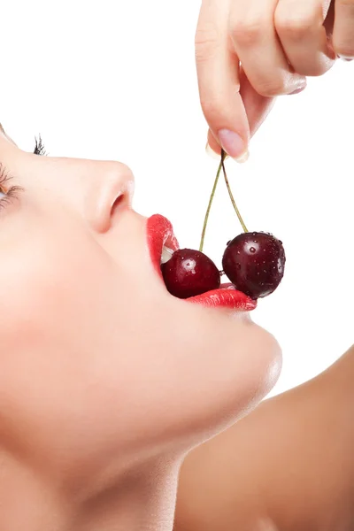 stock image Young woman's mouth with red cherries