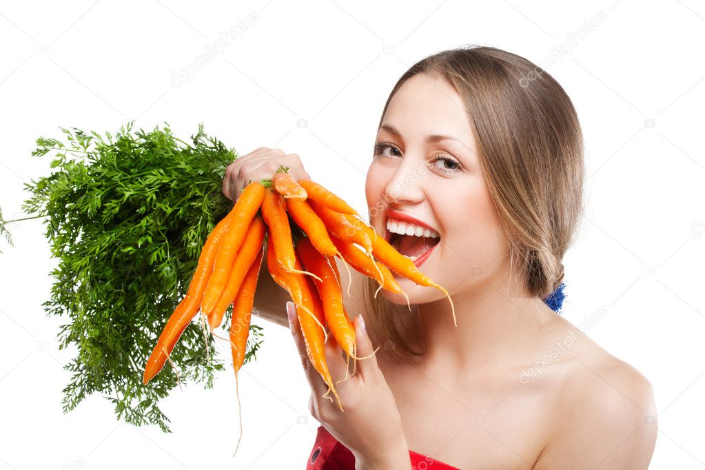 Attractive woman holds bunch of carrots