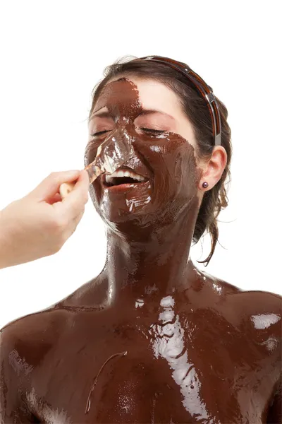 Stock image Young woman having a chocolate face mask