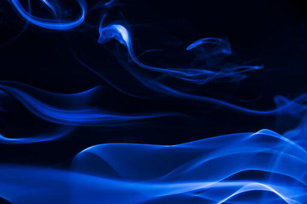 Abstract blue smoke shot against black background