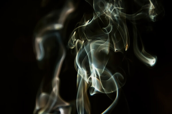 Abstract green and orange smoke shot against black background