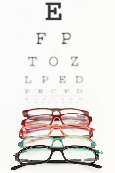 Eyeglasses on an eye chart — Stock Photo, Image