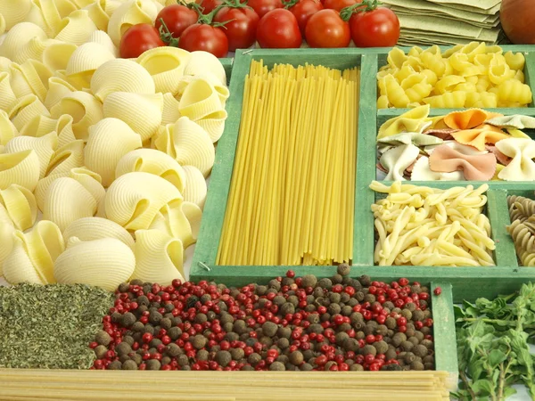 Pasta collection in wooden box and ingredients — Stock Photo, Image