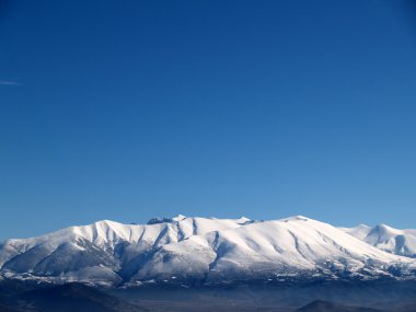 Olympus Mountain covered by snow in Greece clipart