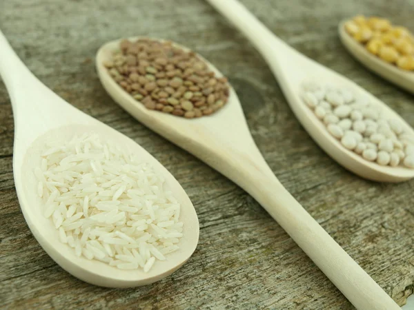 Legumes over spoons — Stock Photo, Image