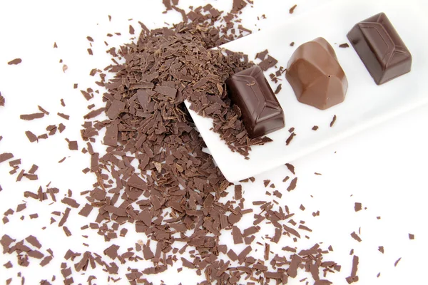 Chocolates and grate of chocolate — Stock Photo, Image
