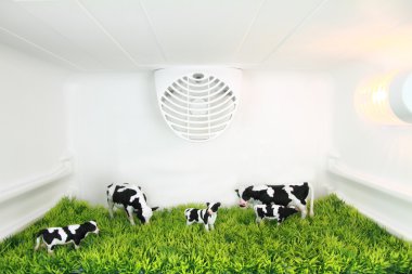 Freshness concept. A field with cows inside the fridge clipart