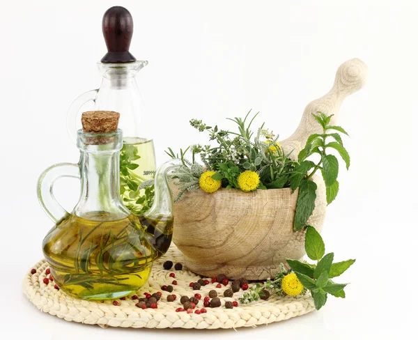 Mozsár, gyógynövények és üveg olívaolaj — Stock Fotó