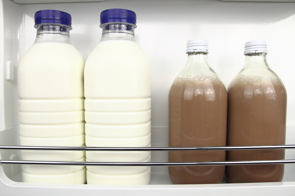 Bottles of white and chocolate milk in the fridge