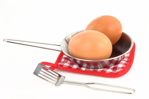 Frigideira com ovos em um fundo branco — Fotografia de Stock