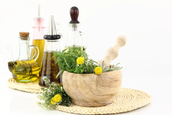 Mozsár, gyógynövények és üveg olívaolaj — Stock Fotó