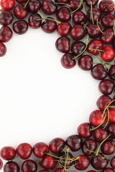 Cherry border in shape of heart on white background — Stock Photo, Image
