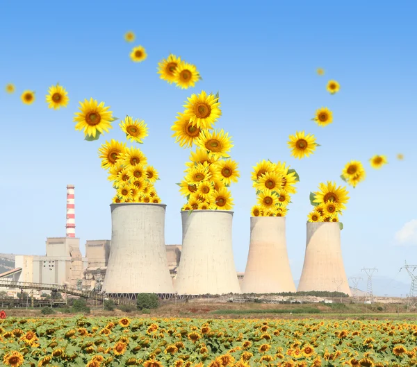 Sunflowers come out from chimneys of a power plant — Stock Photo, Image