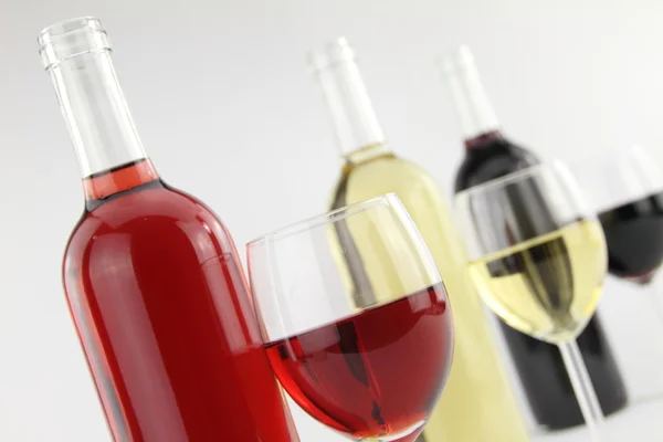 Üç renk şarap şişeleri ve gözlük — Stok fotoğraf