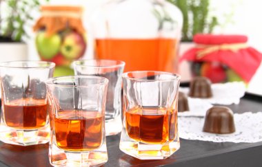 Homemade liqueur in small glasses clipart