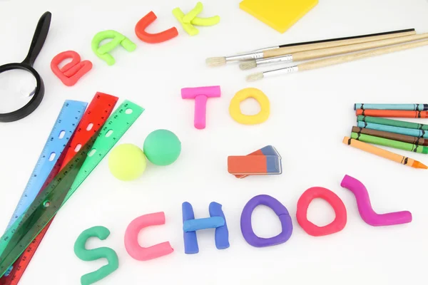Plasticine letters spelling back to school and school office supplies — Stock Photo, Image