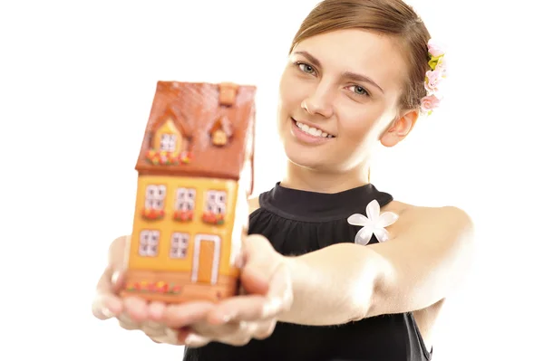 Young woman holding a house — Stock Photo, Image