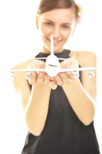 Young woman holding a plane — Stock Photo, Image