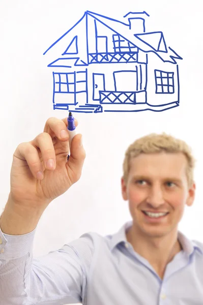 Young man with a plan of a house — Stock Photo, Image