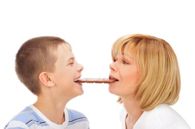 Portrait of happy european family of son and his mother eating c clipart