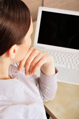 Portrait of a beautiful young businesswoman looking at the scree clipart