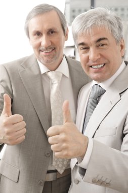 Portrait of two businessmen who approve. clipart