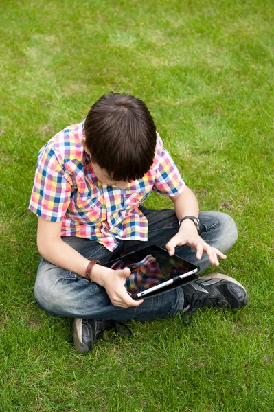 Young boy outdoors on the grass at backyard — Stock Photo, Image
