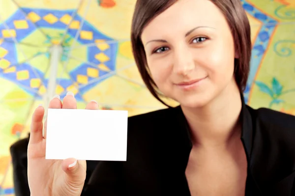 Closeup portrait of young pretty woman holding business card — Stock Photo, Image