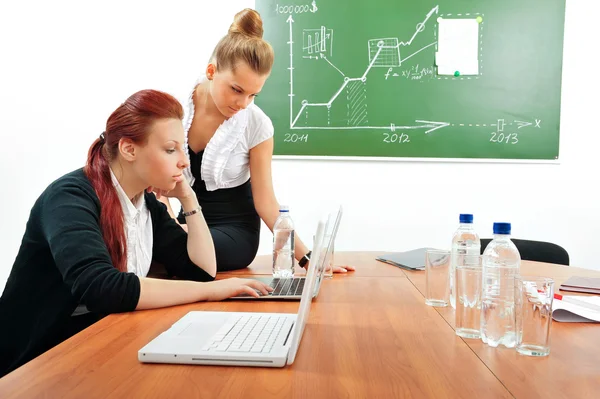 Portrait of two young business women at their office — Stock Photo, Image